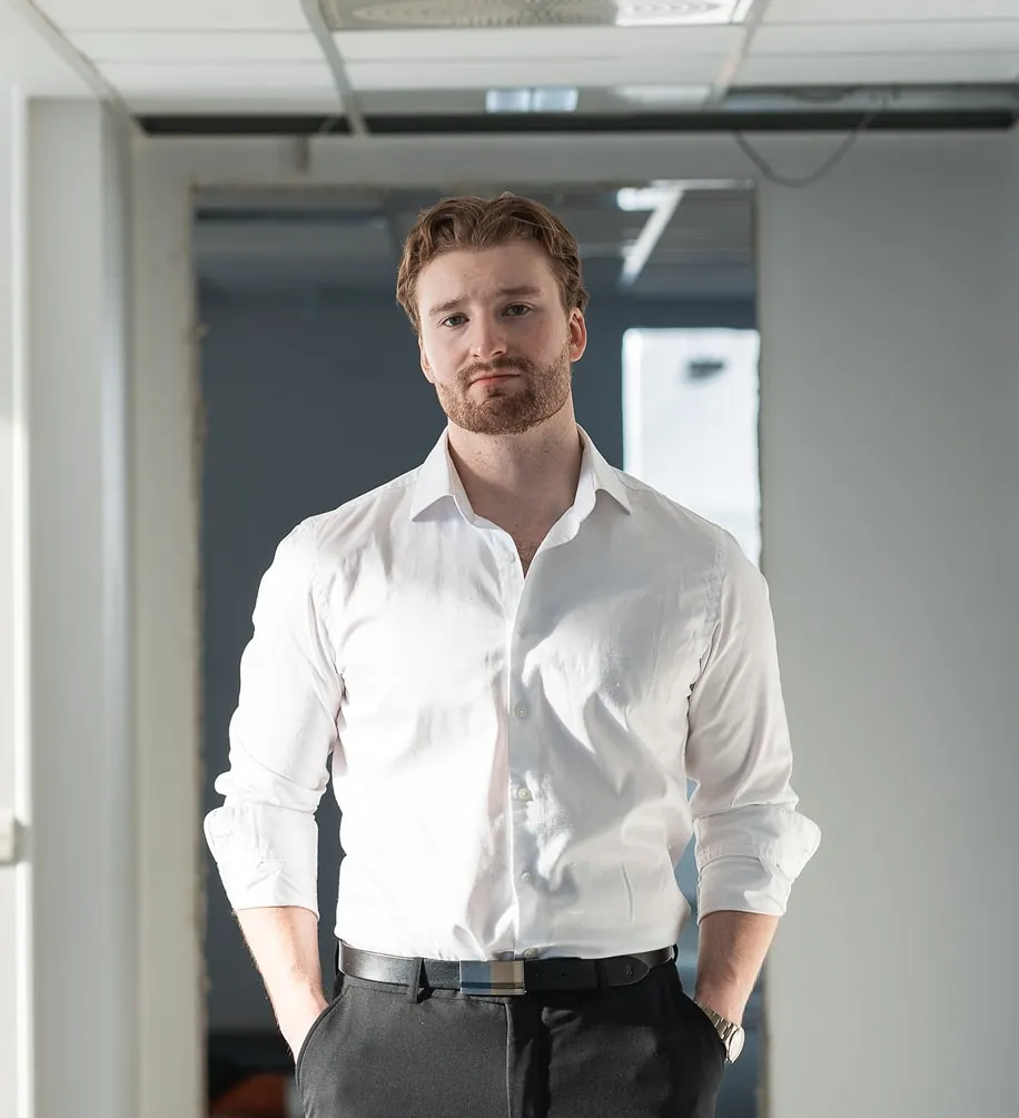 Fredrik in a white shirt, in an office corridor